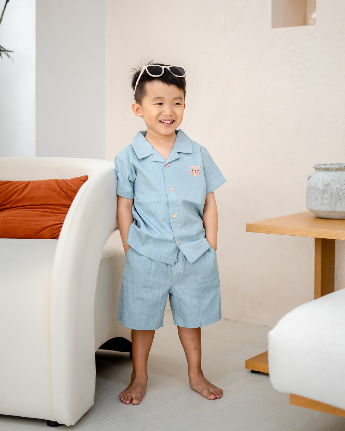 Child smiling in LeBear Liam Denim Camp Collar Set, 100% premium cotton with classic camp collar design