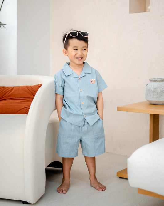 Child smiling in LeBear Liam Denim Camp Collar Set, 100% premium cotton with classic camp collar design