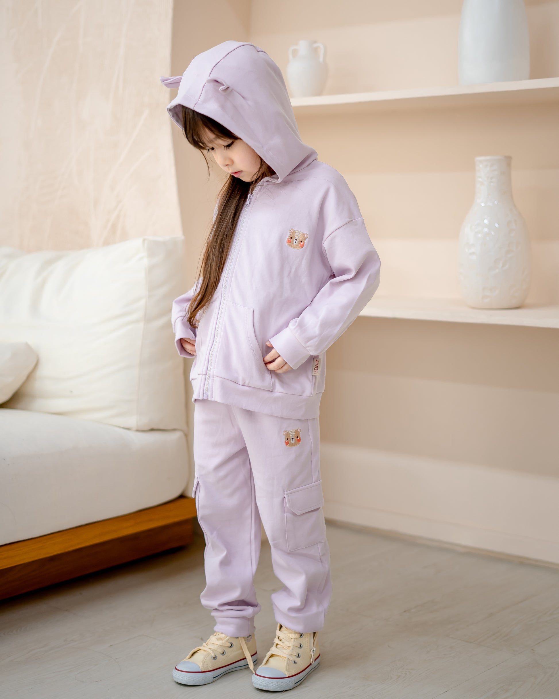 Girl in LeBear lilac hooded jacket with bear ears and matching jogger pants, made from premium cotton.