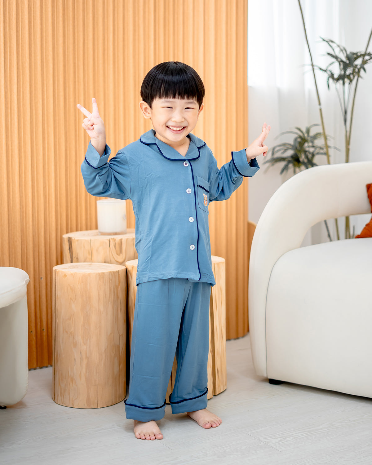 Boy wearing LeBear Luxe Bamboo Pyjamas in Dusk Blue, 95% bamboo 5% spandex with contrast piping and bear embroidery