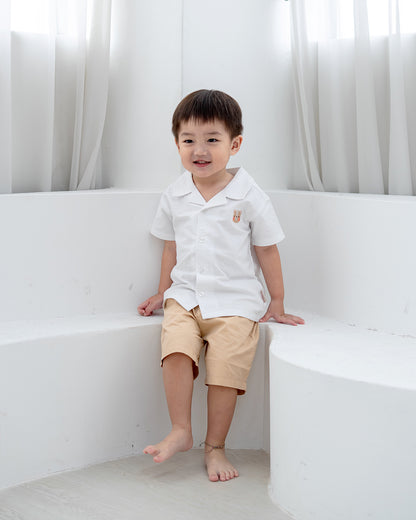 Child sitting while wearing LeBear Maison Camp Collar Shirt in White