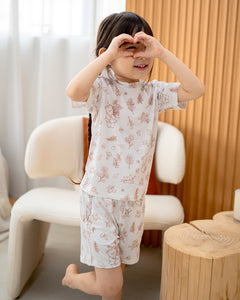 Child playing while wearing LeBear Meadow Mocha TENCEL kids set