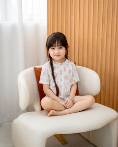 Child wearing LeBear Meadow Mocha TENCEL kids set with floral bear print