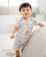 Full body view of baby wearing LeBear Meadow TENCEL baby romper in a minimal home setting