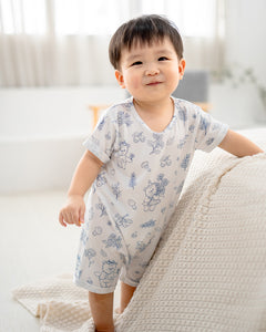 Full body view of baby wearing LeBear Meadow TENCEL baby romper in a minimal home setting