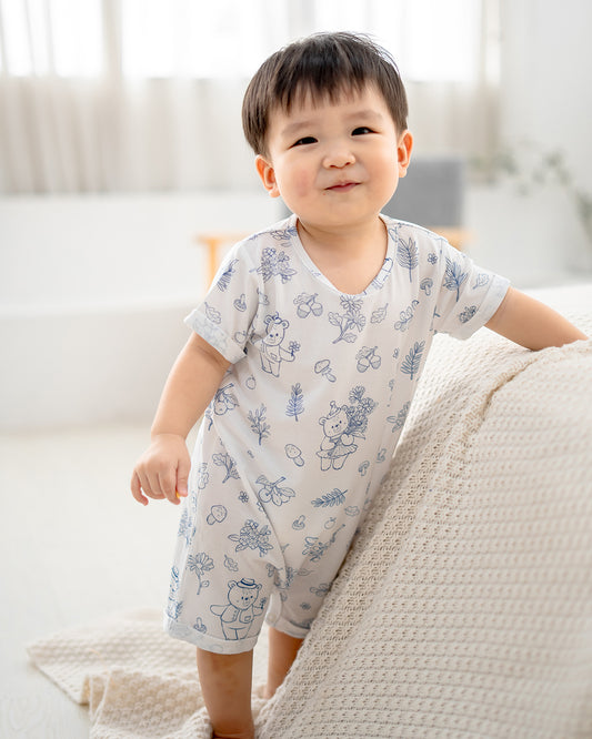 Full body view of baby wearing LeBear Meadow TENCEL baby romper in a minimal home setting