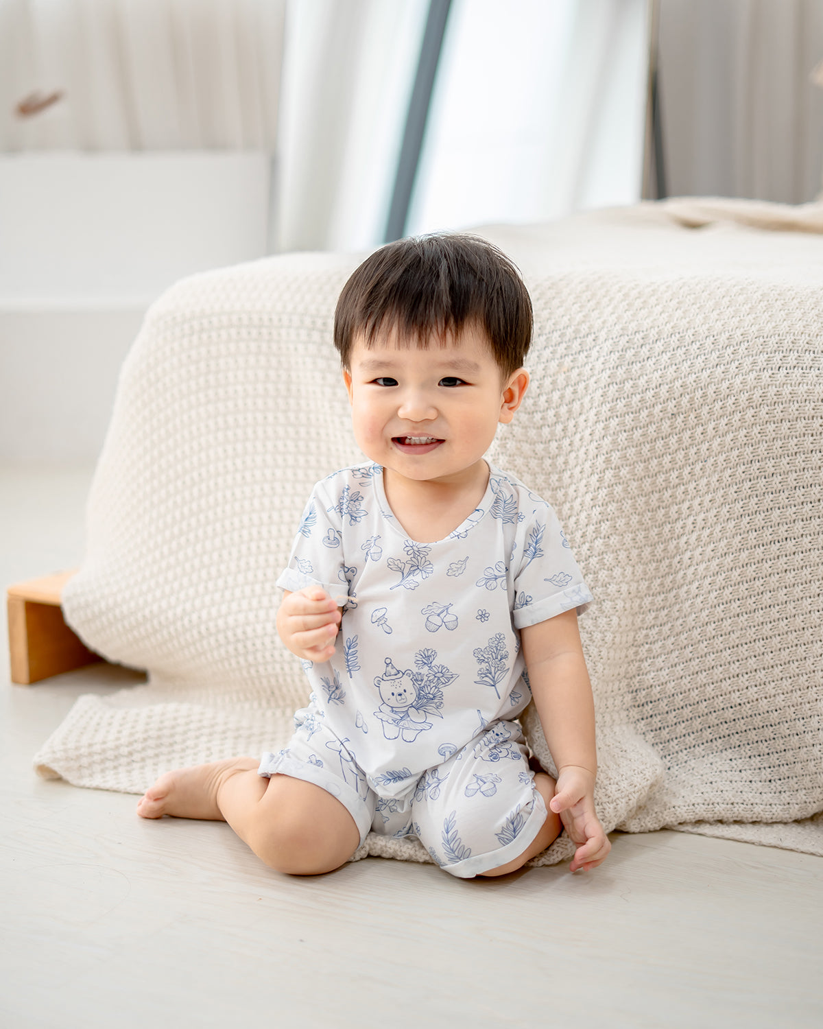 Baby wearing LeBear Meadow TENCEL baby romper sitting comfortably indoors