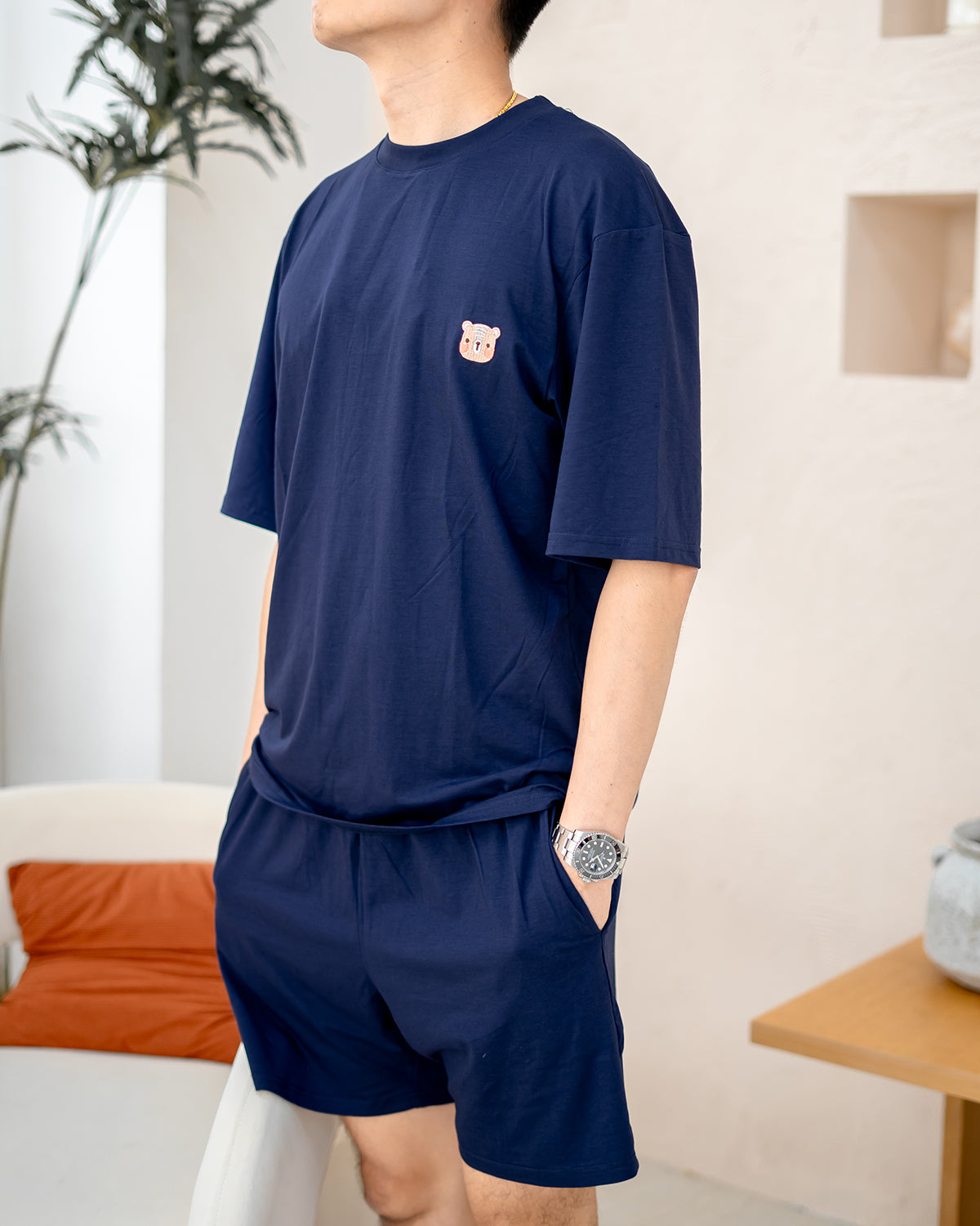 Close-up of embroidered bear logo on LEBEAR TENCEL™ Men’s Set in Navy.