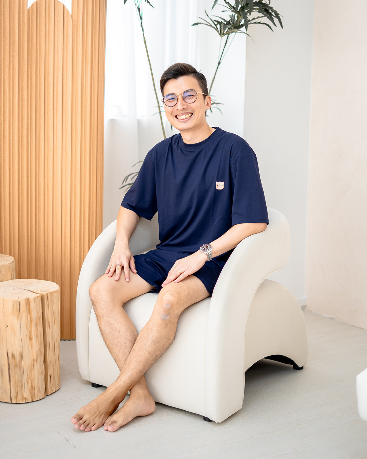 Man sitting comfortably in LEBEAR Men’s TENCEL™ Set in Navy — premium soft loungewear for men.