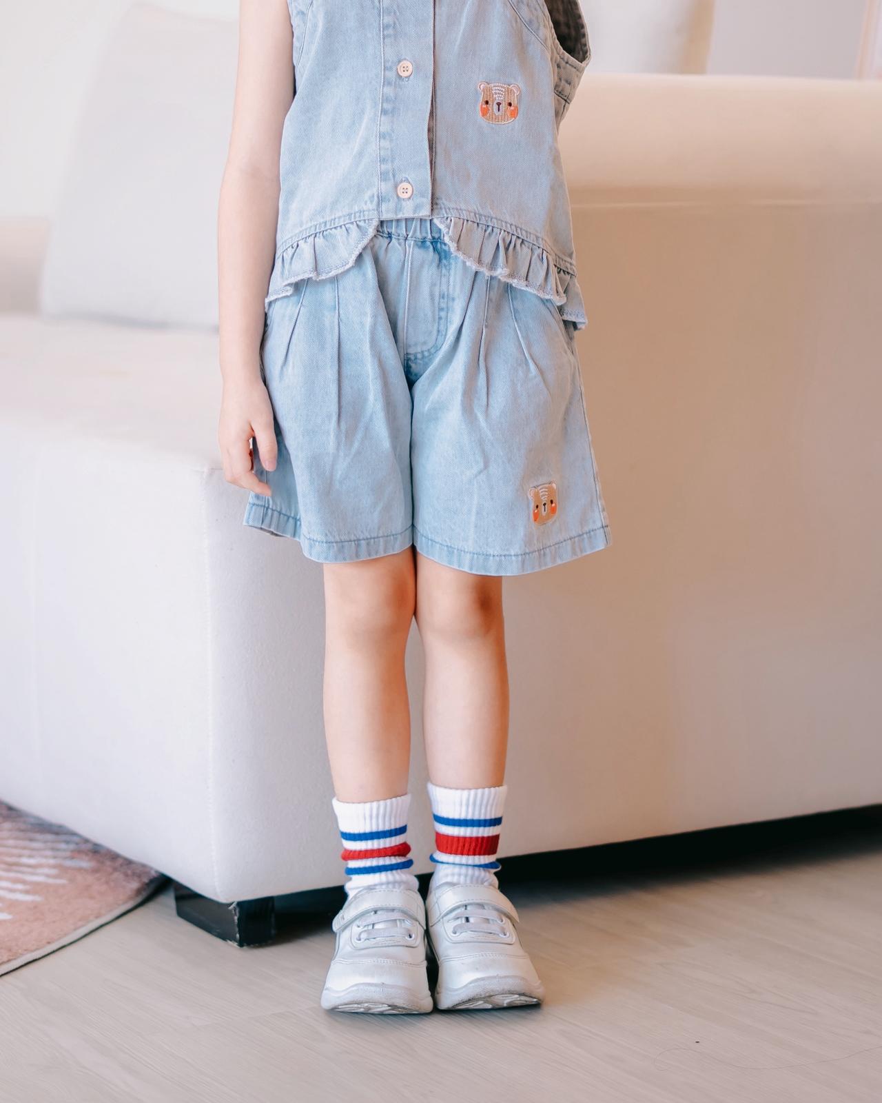 Close-up of LeBear Mia Ruffle Denim Shorts made from 100% premium cotton with bear embroidery and elastic waistband