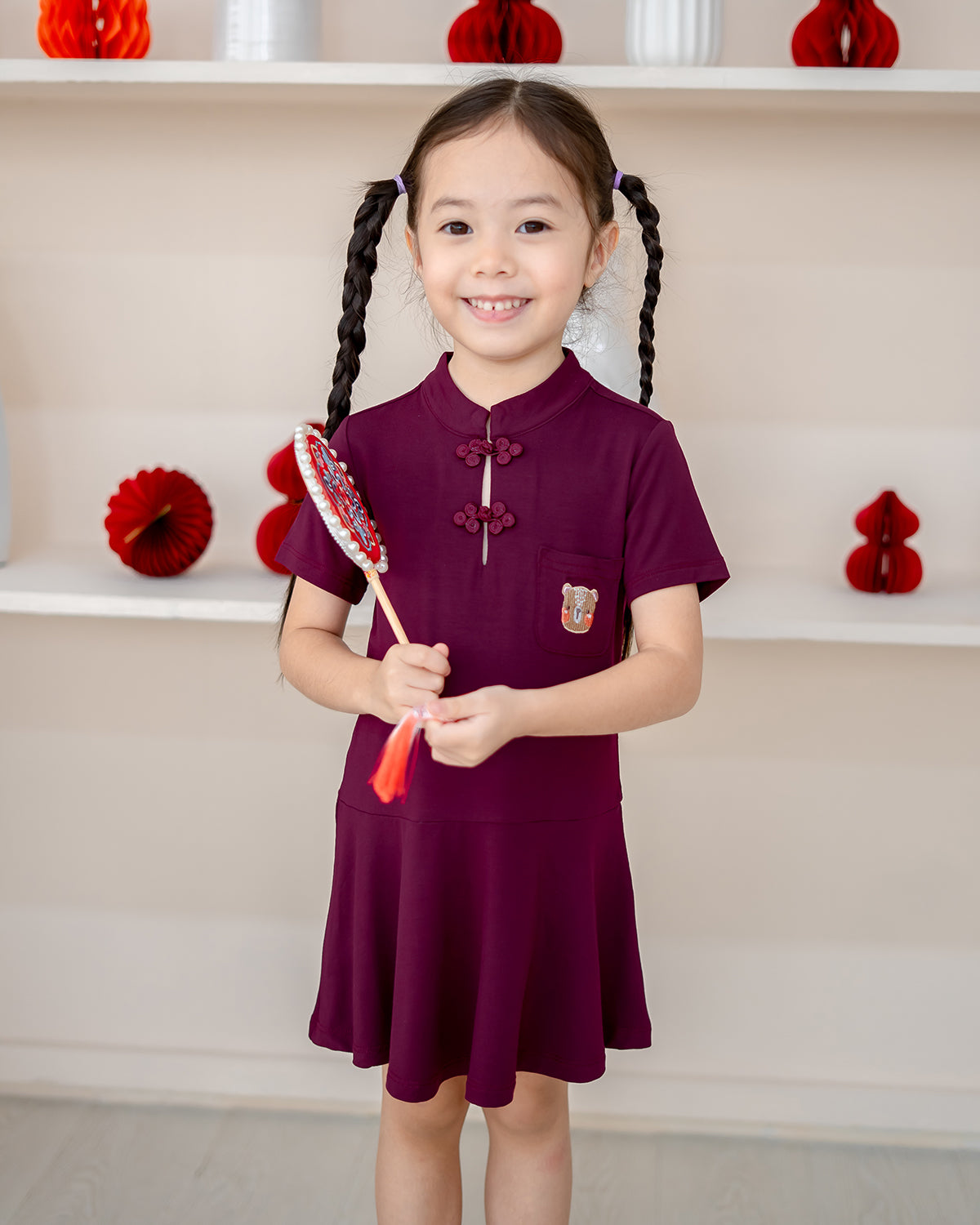 Girl wearing LeBear Plum Blossom Bamboo Cheongsam – kids CNY dress in plum