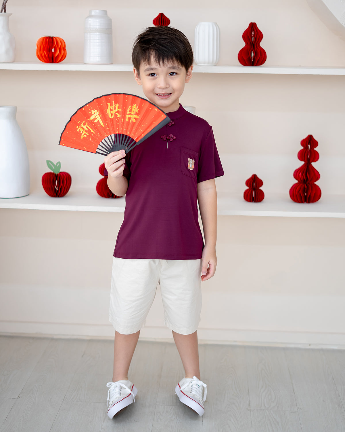 Boy wearing LeBear Plum Blossom Mandarin Set – bamboo CNY outfit