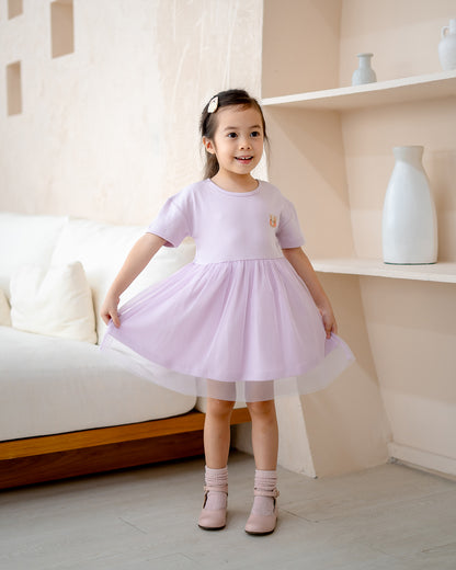 “Lifestyle photo of child wearing LeBear Roselle Tulle Dress in Lilac Mist”
