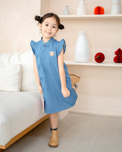 Playful pose in Denim Serenity Cheongsam – kids CNY outfit