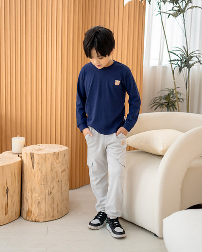 Kid wearing Lebear signature embroidery long sleeve tee in deep sea blue with relaxed everyday fit