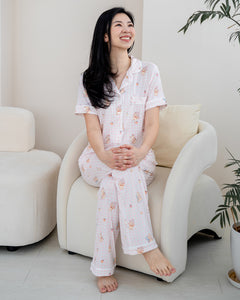 Woman relaxing in LeBear Sweet Scoop adult bamboo pyjamas with breathable bamboo fabric and signature ice cream teddy bear print.