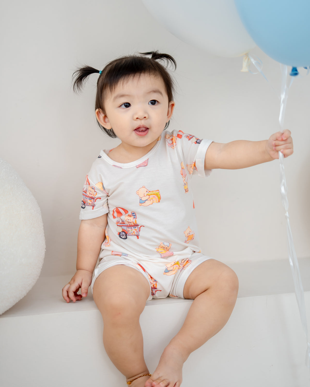 Close-up of baby wearing LeBear TENCEL™ onesie with Uncle Bear Ice Cream Truck print