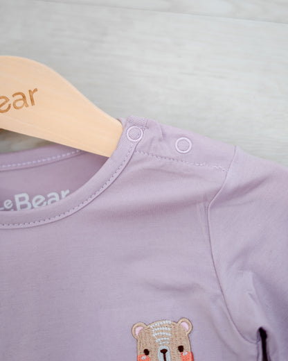 Shoulder snap button detail on LEBEAR TENCEL™ Lilac onesie — easy dressing for infants.
