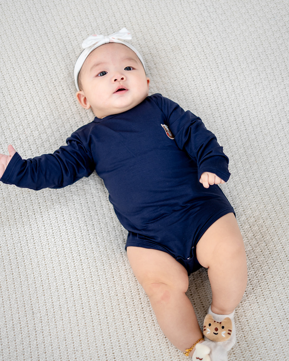 Baby in cozy LEBEAR TENCEL™ Long Sleeve Onesie Navy — soft, sustainable baby wear Singapore.