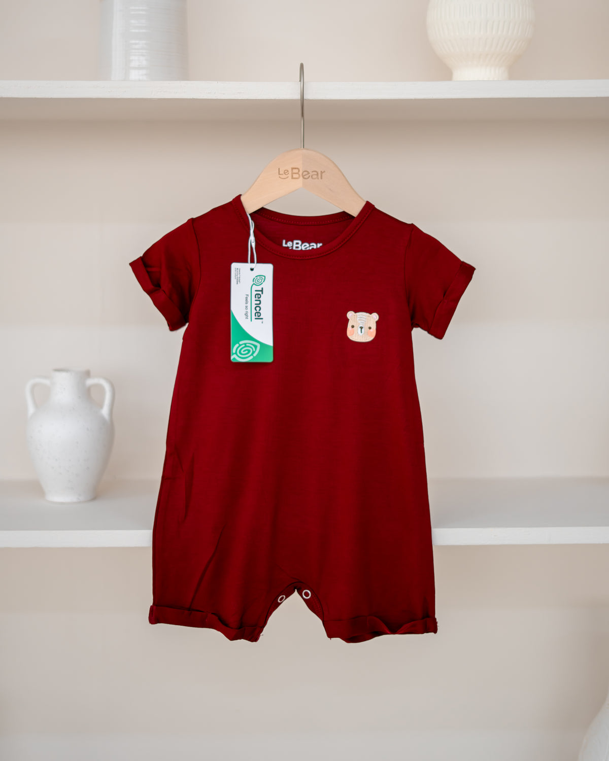 LeBear TENCEL™ Onesie in Ruby with signature bear embroidery and snap button opening
