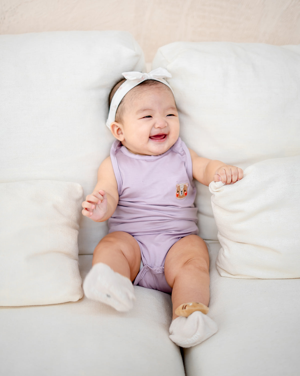 Baby laughing in LEBEAR TENCEL™ Tank Onesie Lilac — eco-friendly and ultra-soft baby romper.