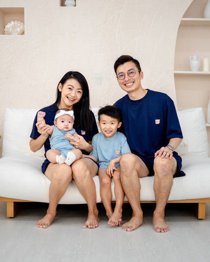Siblings in matching LEBEAR TENCEL™ Sky Blue outfits on sofa – family matching collection Singapore.