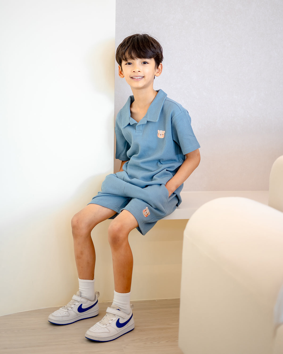 Boy wearing LeBear Waffle Collar Set in blue, 100% premium cotton waffle texture with fluffy bear embroidery