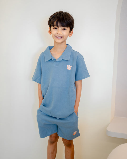 Boy posing in LeBear 100% premium cotton Waffle Collar Set, soft tagless design in blue tone