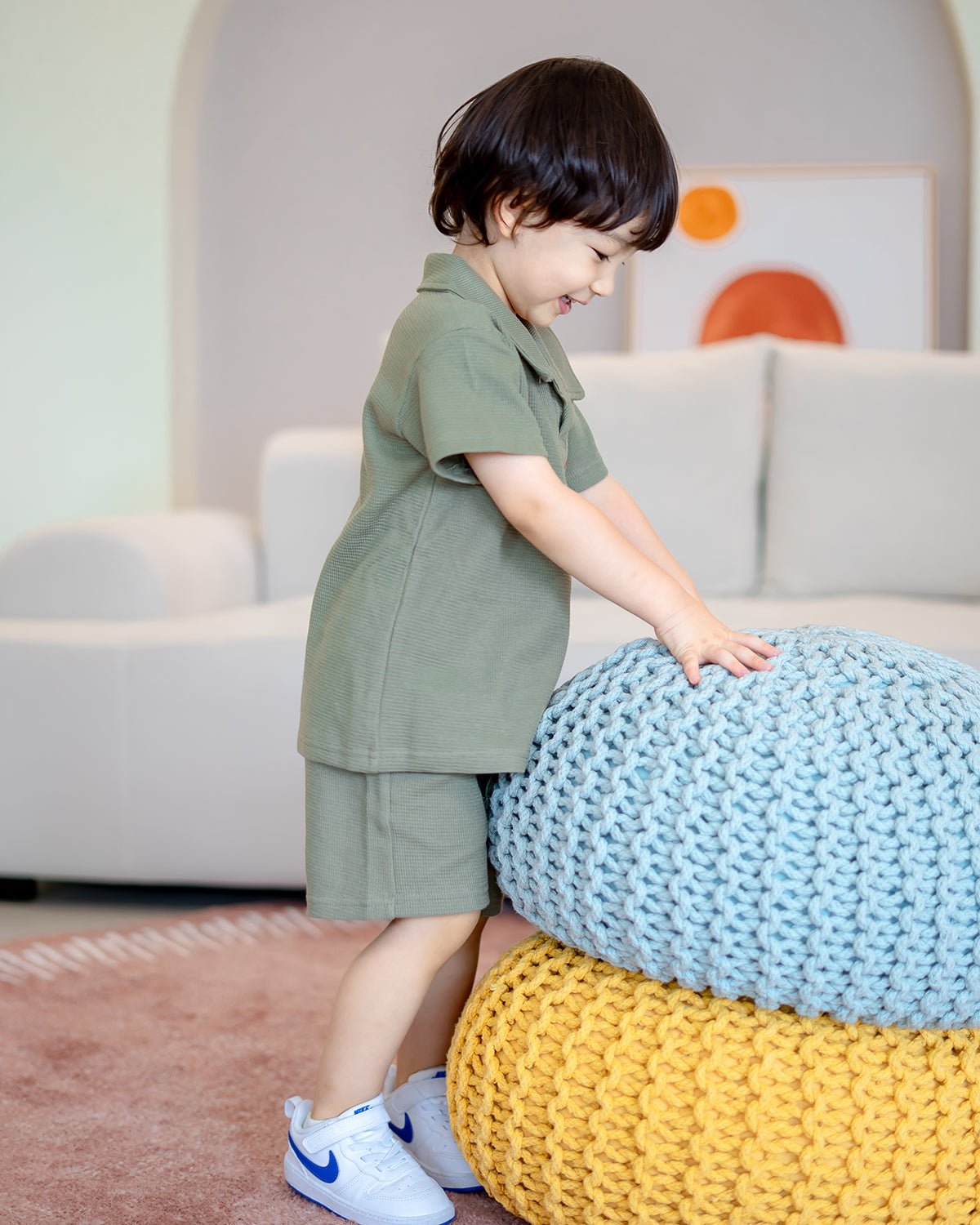 Child in LeBear green waffle collar top and shorts, breathable cotton texture outfit for kids