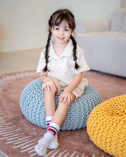 Girl sitting on knitted cushion in 100% premium cotton waffle set by LeBear