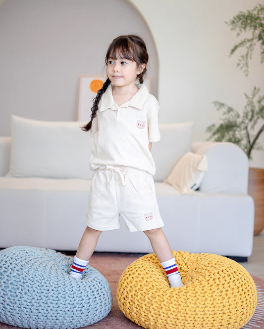 Kid posing in LeBear cotton waffle top and shorts with drawstring waistband