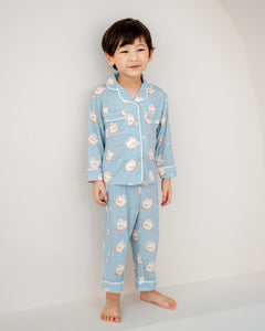 Child wearing Little Dreamer kids bamboo pyjamas pants set in aqua blue
