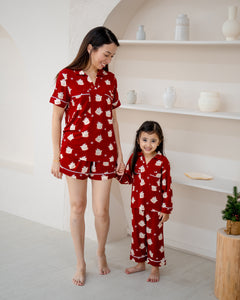 Child wearing Little Dreamer buttonless bamboo pyjamas in red with matching mum
