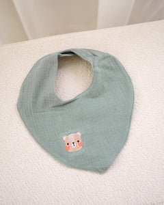 Sage green muslin cotton baby bib. gentle and sustainable for babies.