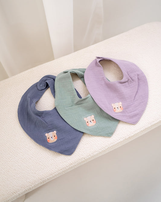 Set of muslin cotton baby bibs in lilac, sage green and navy with bear embroidery