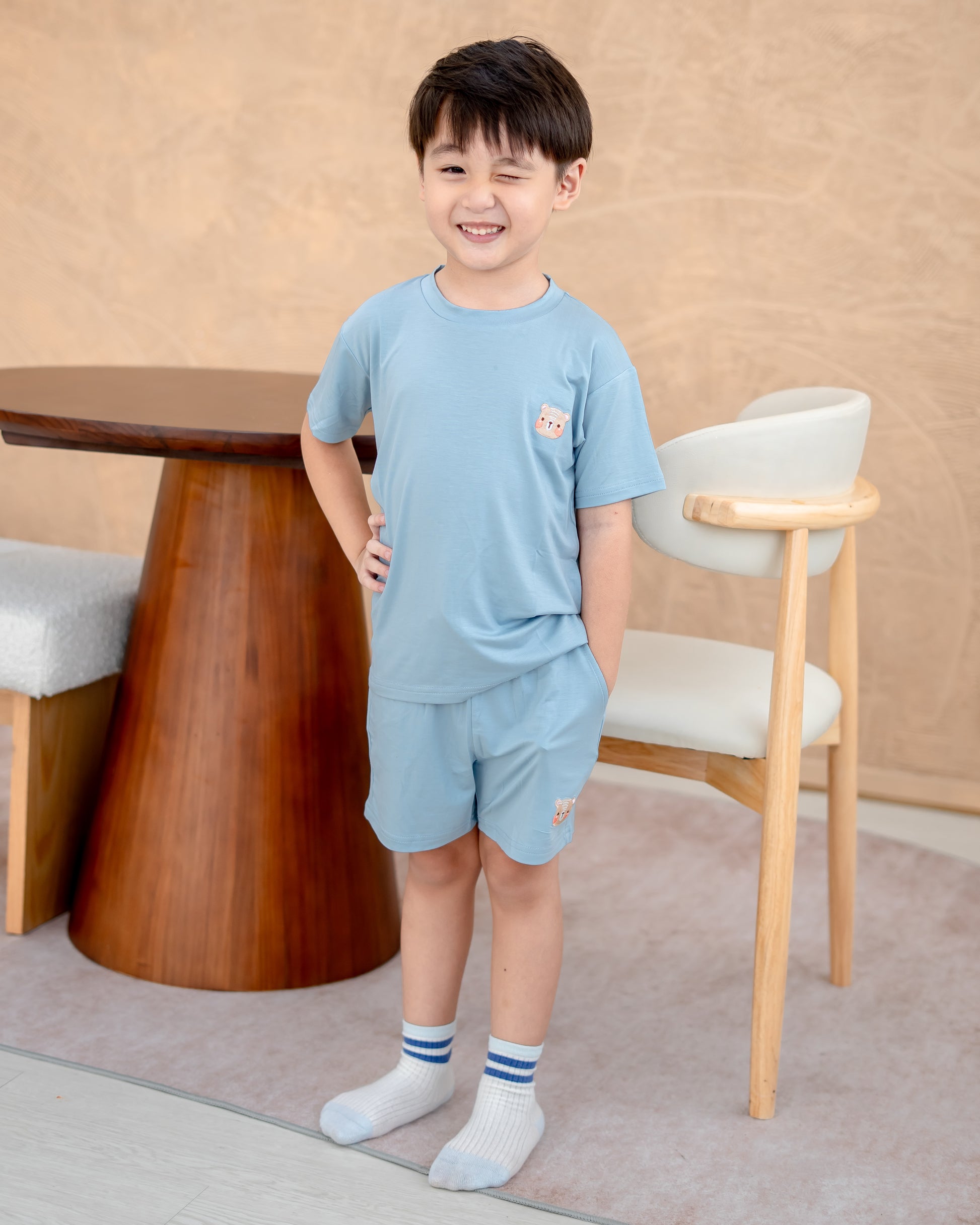 hild wearing eco-friendly skyblue kids loungewear set designed in sustainable Lenzing TENCEL™ Lyocell for all-day comfort