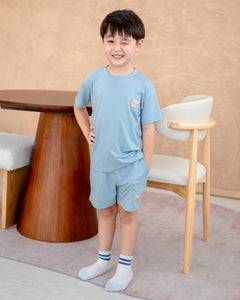 hild wearing eco-friendly skyblue kids loungewear set designed in sustainable Lenzing TENCEL™ Lyocell for all-day comfort