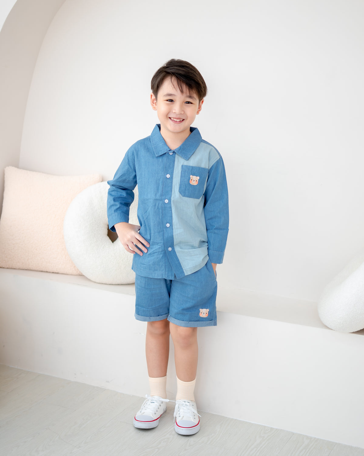 Boy wearing LeBear two-tone denim shirt featuring signature bear embroidery