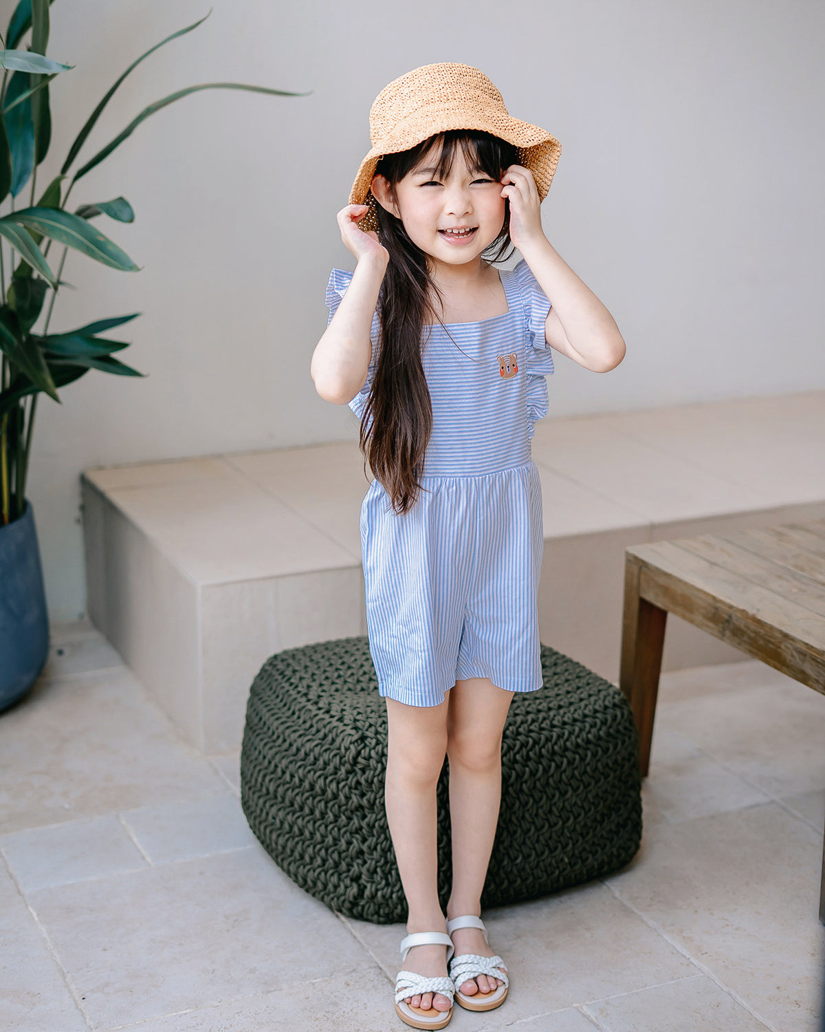 Girl wearing LeBear Wander & Wonder Kids Stripe Playsuit in Sky Blue.