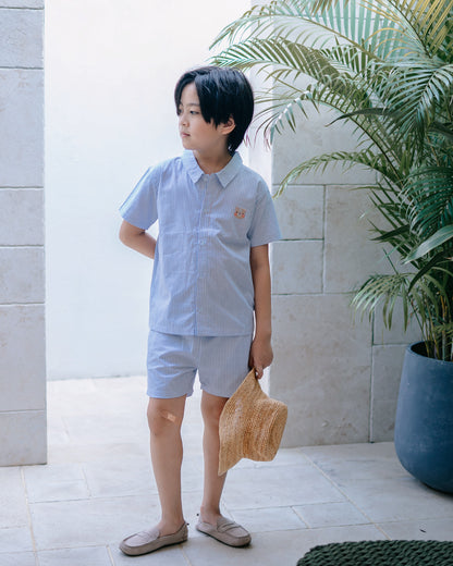 Boy wearing a Sky Blue striped cotton resort set from the Wander & Wonder collection.
