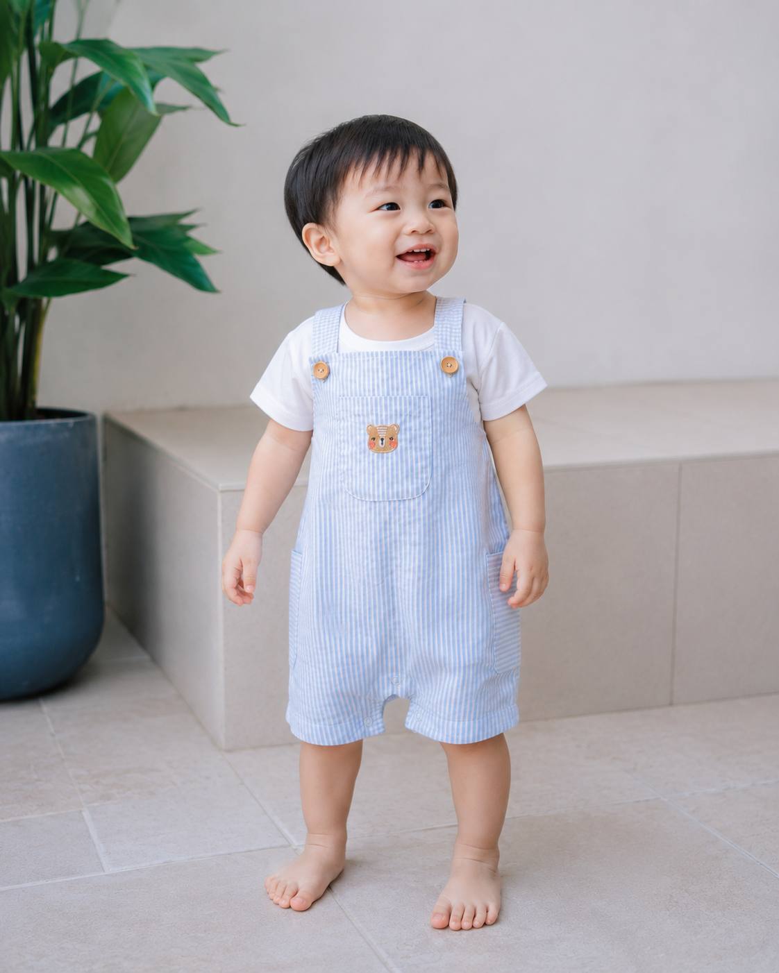Toddler wearing LeBear Wander & Wonder Kids Stripe Romper in Sky Blue.