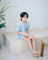 Boy wearing Ocean Blue TENCEL lounge set with ocean-inspired print