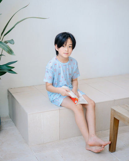 Boy wearing Ocean Blue TENCEL lounge set with ocean-inspired print