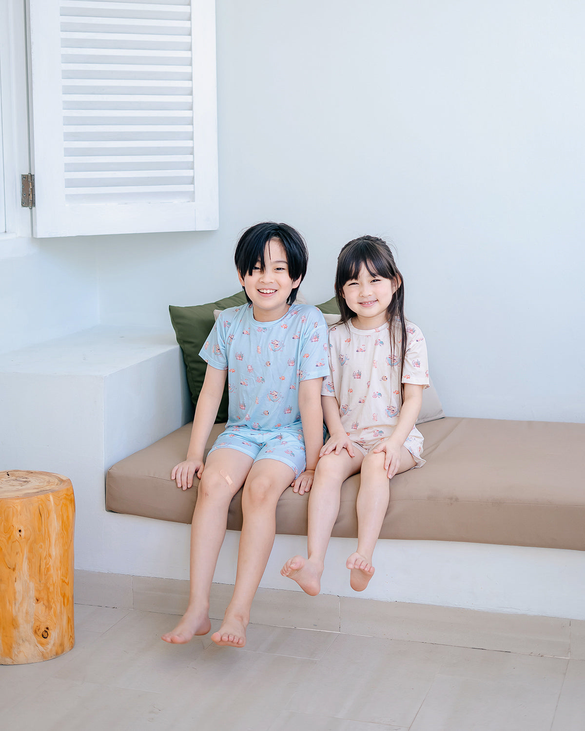Siblings wearing LeBear Wander & Wonder Kids TENCEL lounge sets sitting down.
