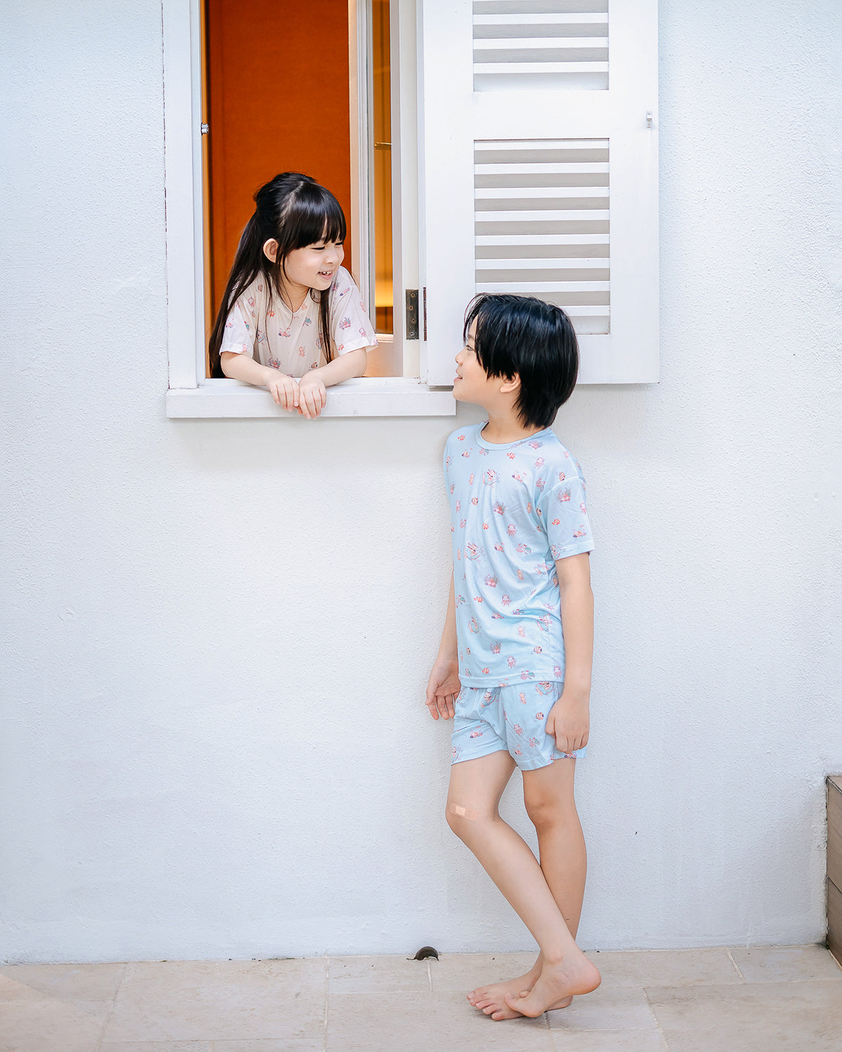 Children wearing matching Wander & Wonder Kids TENCEL™ Lounge Sets in Ocean Blue and Seashell Sand.